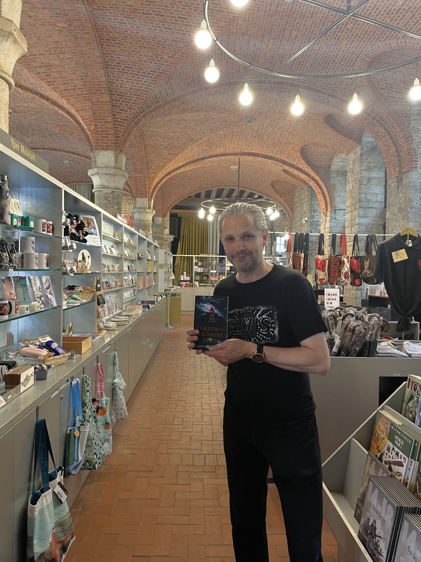 Chris Waddington holding Christmas in Flanders Fields in the In Flanders Fields Museum shop, Ypres